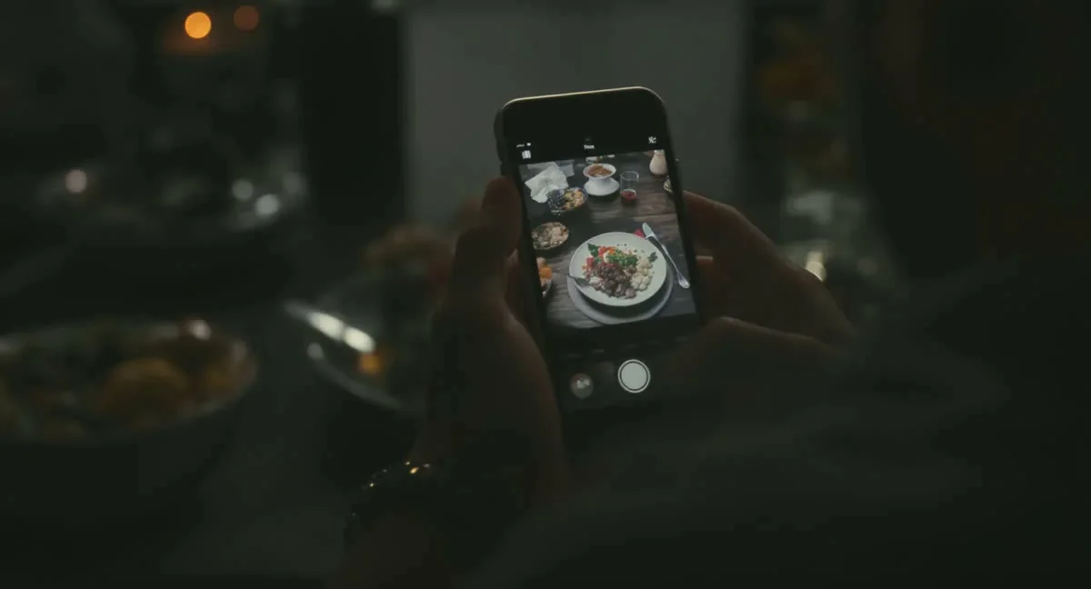 Hand fotografiert eine Mahlzeit mit dem Smartphone